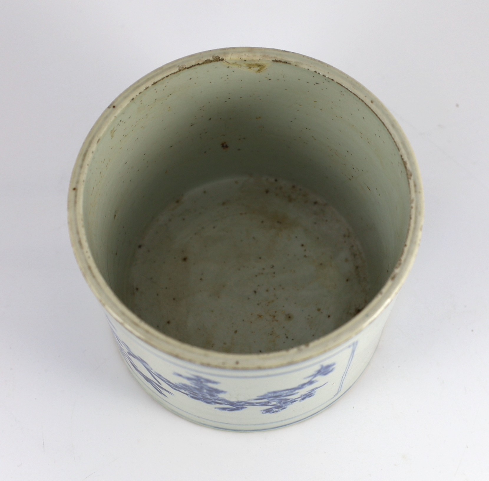 A Chinese blue and white ‘landscape’ brushpot, bitong, Kangxi period, 17.8cm diameter, 15.2cm high, fritting to edges